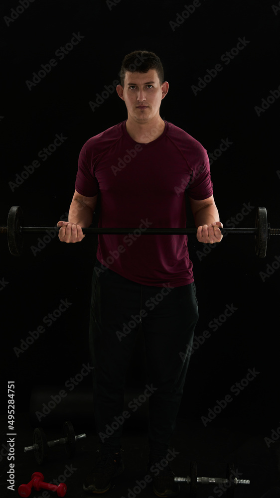 Biceps curl with barbell, standing, isometric contraction. Man exercising with weights. Biceps curl with barbell, standing, isometric contraction. Man exercising with weights.