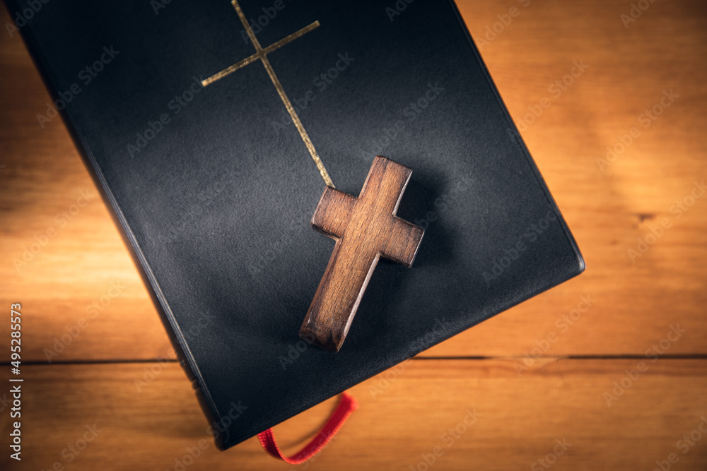 wooden Christian cross on holy Bible