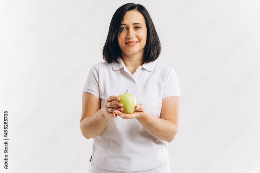 Dentist doctor holding a green apple in the studio, mock up Dentist doctor holding a green apple in the studio, mock up