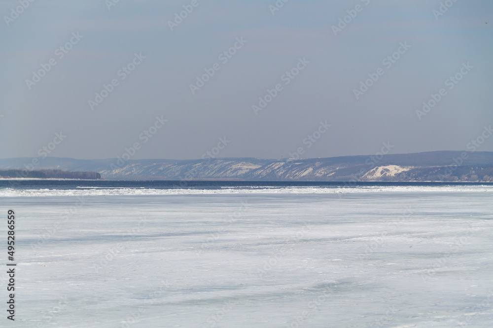 ice on the river.spring landscape with sunlight and mountains. blue river with ice and snow. ice on the river.spring landscape with sunlight and mountains. blue river with ice and snow.