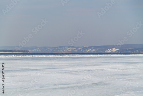 ice on the river.spring landscape with sunlight and mountains. blue river with ice and snow.