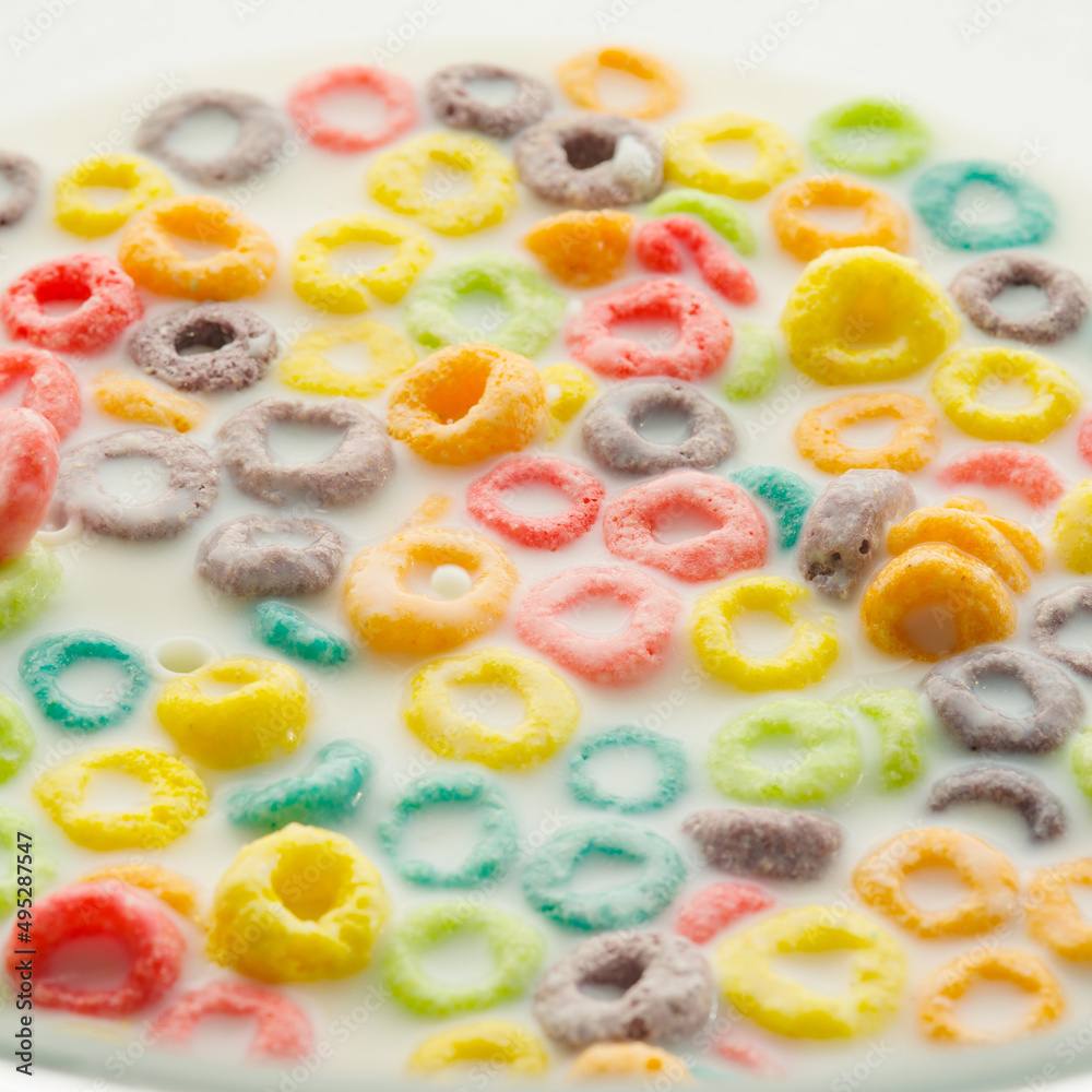 Quick breakfast cereals. Colored fruit rings in milk. Healthy baby food, school breakfasts, healthy lifestyle, healthy food. Abstraction. Close-up. Food background. Quick breakfast cereals. Colored fruit rings in milk. Healthy baby food, school breakfasts, healthy lifestyle, healthy food. Abstraction. Close-up. Food background.