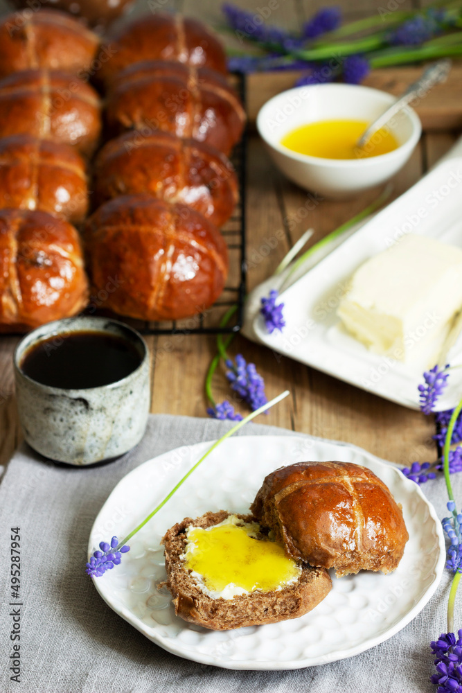 Chocolate cross buns served with butter and honey. Traditional Easter baking.