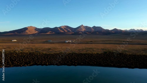 panorama showing environment in kyrgyz yurt camp in kyrgyzstan during sunset photo