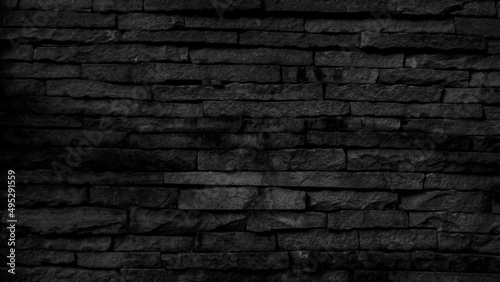 black brick wall background dark stone texture. 