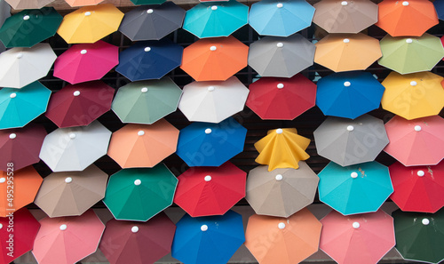 Slika na platnu Lots of colorful umbrellas in the wall, diffrent concept idea, powerlessness con