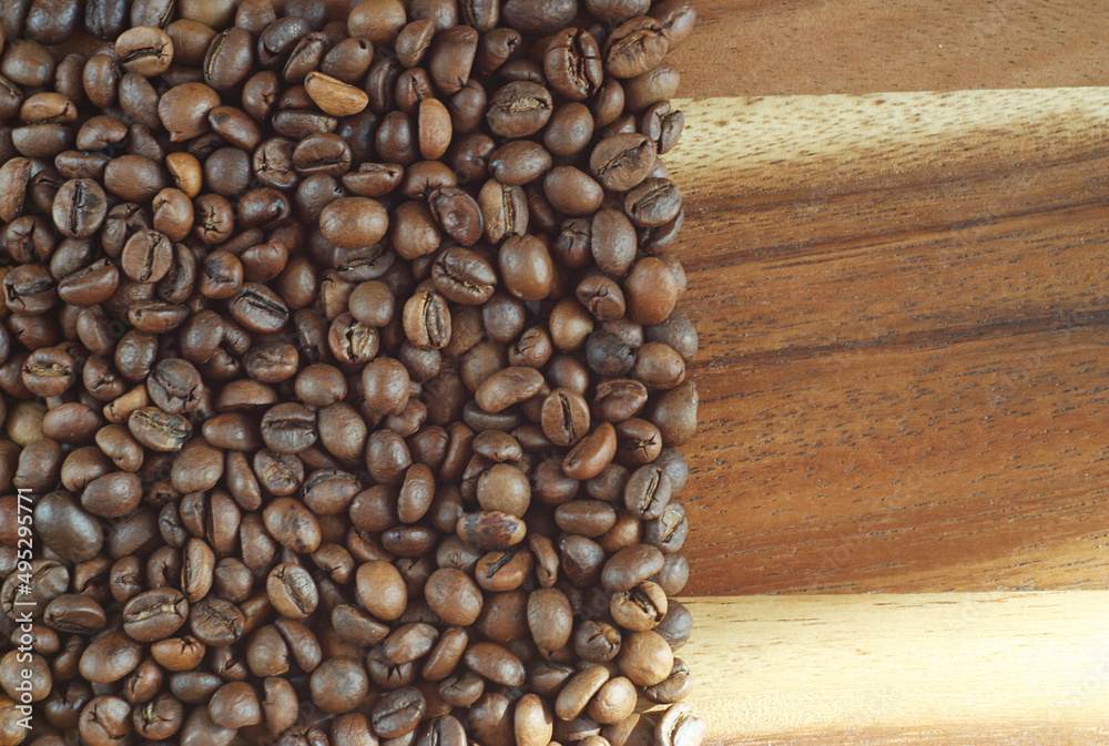 Coffee beans lie on a wooden board. fragrant morning