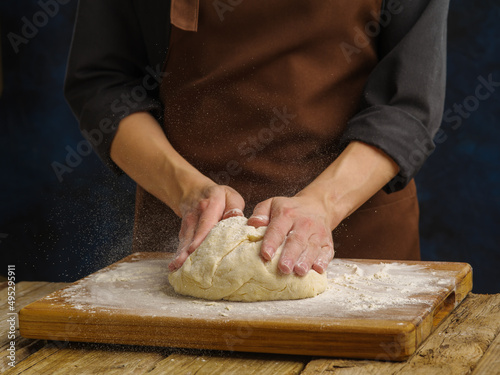 Dough prepared by a professional chef on a wooden background. Close-up. Dough recipes. Restaurant  hotel  cafe  patisserie  home cooking  cookbook  food blog. Advertising. Banner.