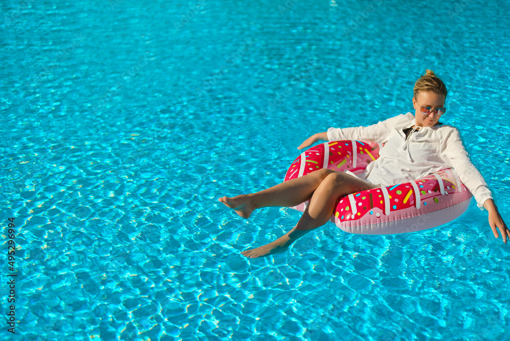 Pretty woman relaxing in swimming pool. Place for text.