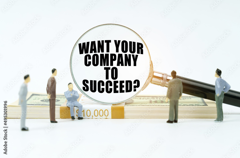 On a white surface, figurines of people and a magnifying glass with the inscription - WANT YOUR COMPANY TO SUCCEED On a white surface, figurines of people and a magnifying glass with the inscription - WANT YOUR COMPANY TO SUCCEED