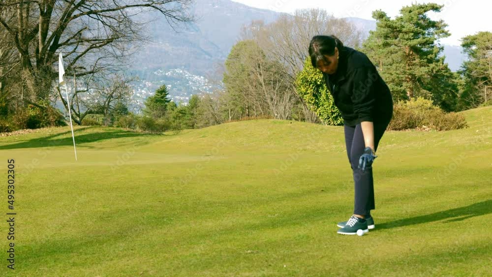 Golfer Dropping the Golf Ball on Fairway in a Sunny Day in Switzerland. Golfer Dropping the Golf Ball on Fairway in a Sunny Day in Switzerland.
