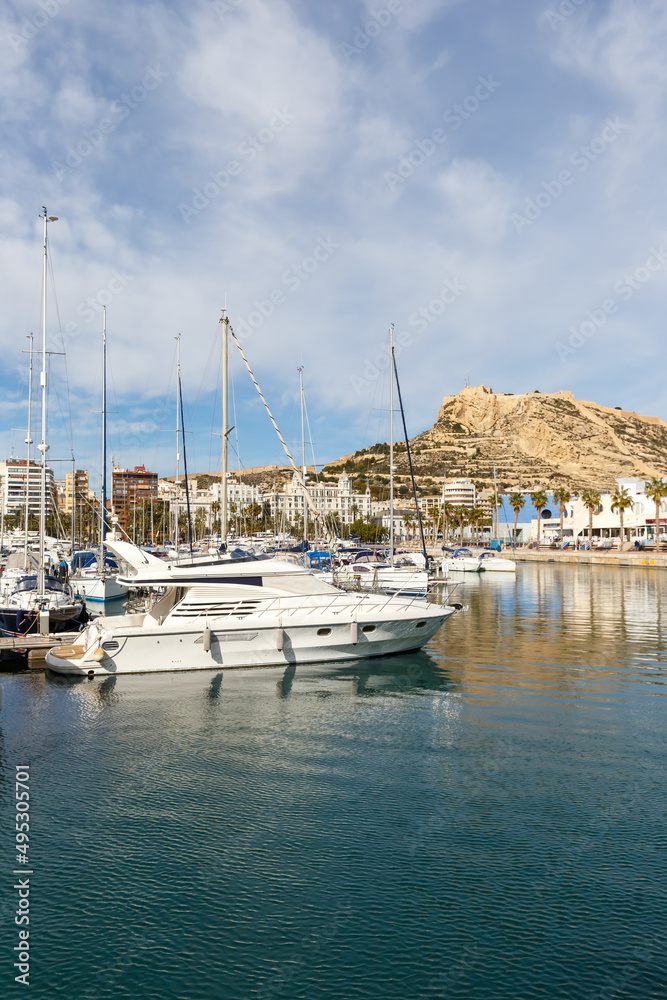 Alicante Port d'Alacant marina with boats and view of castle Castillo travel traveling holidays vacation portrait format in Spain