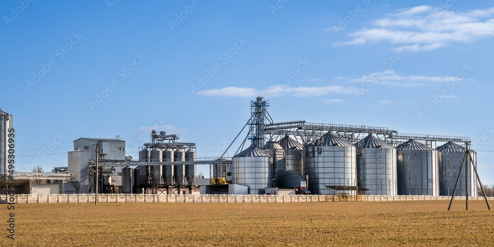panorama view on agro silos granary elevator on agro-processing manufacturing plant for processing drying cleaning and storage of agricultural products, flour, cereals and grain.