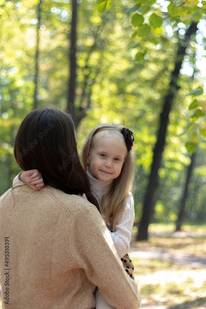 Mom and daughter are hugging in the park. Family walk. Happy mom and daughter. Green Park. Family values. Tenderness and love. Mom and daughter are hugging in the park. Family walk. Happy mom and daughter. Green Park. Family values. Tenderness and love.
