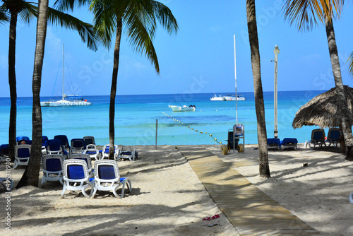 Bayahibe, la Romana, Dominican Republic - Beach on the Caribbean shore and palm trees photo
