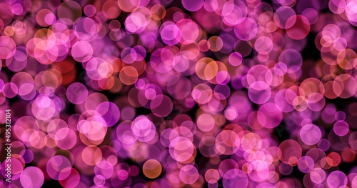 Abstract bokeh image. Pink, fuchsia shiny glitters and bubbles. Defocused, blurred.
