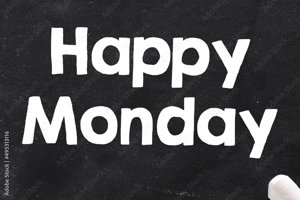 Fototapeta premium Happy Monday text written on black chalk board.