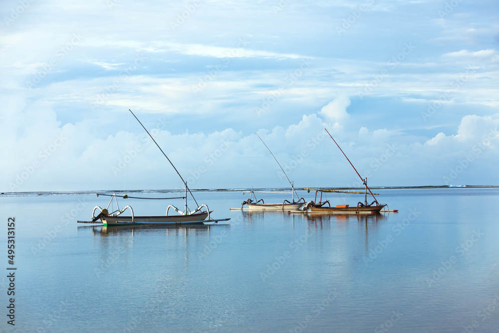 Bali island, Indonesia. Summer vacation. Fishing boats floating on the