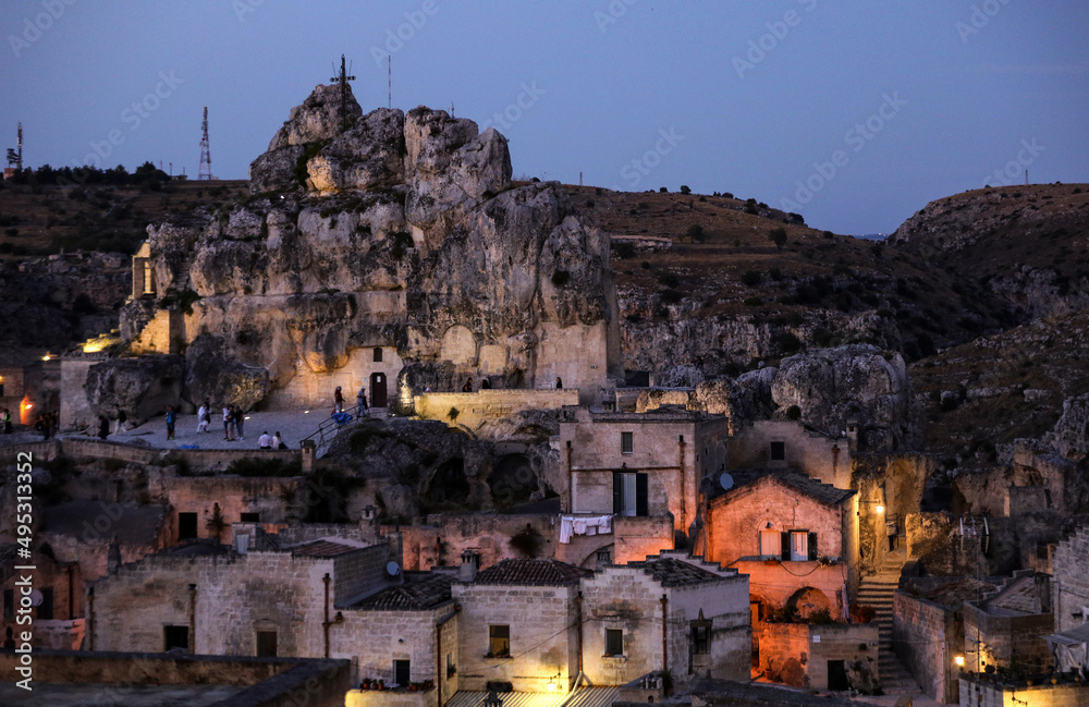 Amazing lighted buildings in ancient Sassi district by night in Matera, well-known for their ancient cave dwellings. Basilicata. Italy Amazing lighted buildings in ancient Sassi district by night in Matera, well-known for their ancient cave dwellings. Basilicata. Italy
