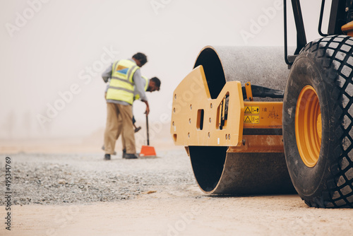 Dozer, excavator, and road rollers working on the mud site repairing and maintenance on the machine and road photo