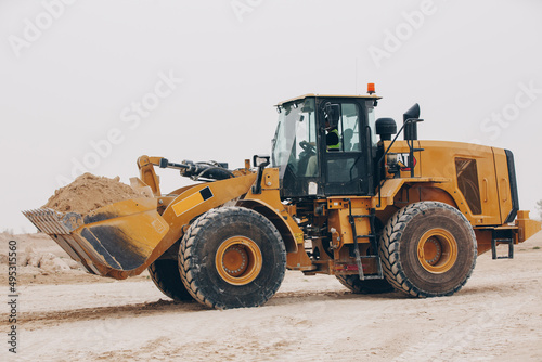 Dozer, excavator, and road rollers working on the mud site