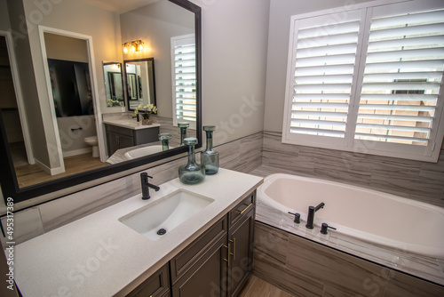 Master Bathroom With Dual Vanities And Bath Tub