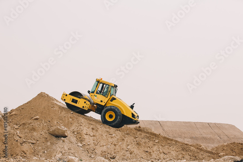 Dozer, excavator, and road rollers working on the mud site