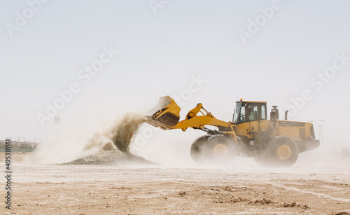 Dozer, excavator, and road rollers working on the mud site