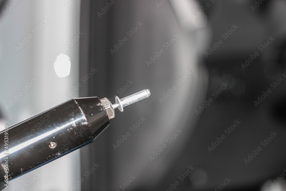 Rivet gun, applicator and rivets. Installing the speaker in the car. An