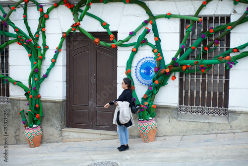 chica en un mural artistico en una calle de un pueblo de cordoba photo