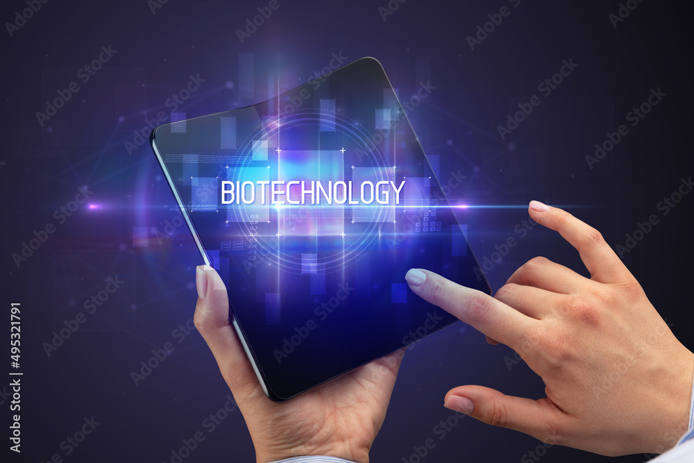 Businessman holding a foldable smartphone Businessman holding a foldable smartphone