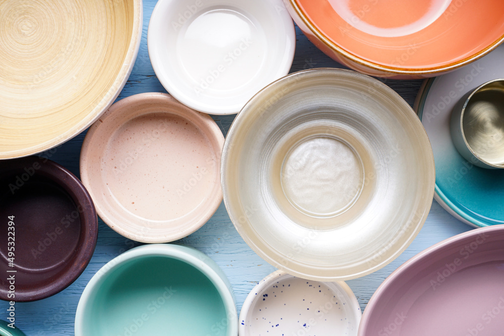 Dishes for serving and eating meals on a wooden background, top view. Modern ceramic and wooden crockery, trendy tableware, close-up. Dishes for serving and eating meals on a wooden background, top view. Modern ceramic and wooden crockery, trendy tableware, close-up.