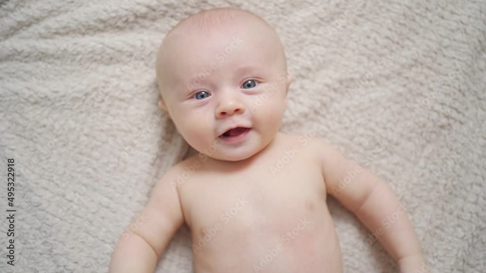 top view. Funny and beautiful baby on the bed. children's health. top view. Funny and beautiful baby on the bed. children's health.