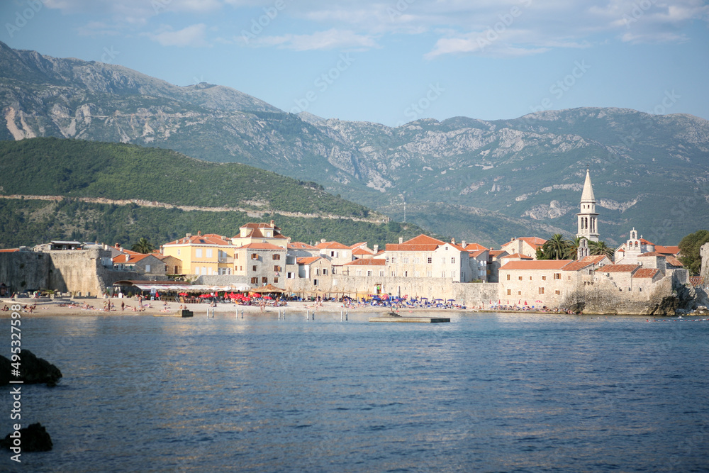 View of old town Budva with city beach, Montenegro. The resort city located in Budva Riviera of Adriatic Sea for poster, branding, calendar, card, banner, cover, post. A place for your design or text