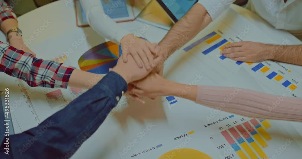 Close-up, a group of people at a team building, stacking hand on hand. Gesture of the winners, successful people stack hand on hand together, uniting the team. View from above. 4k, ProRes
