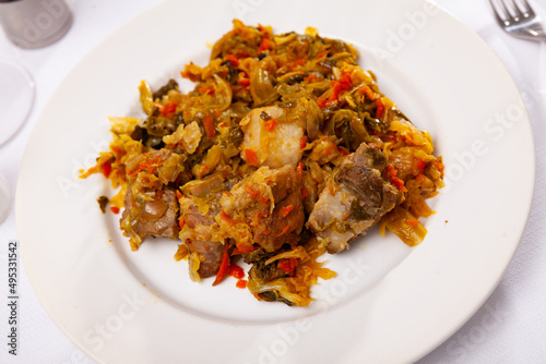 Tasty meat pork served with braised cabbage on a served table