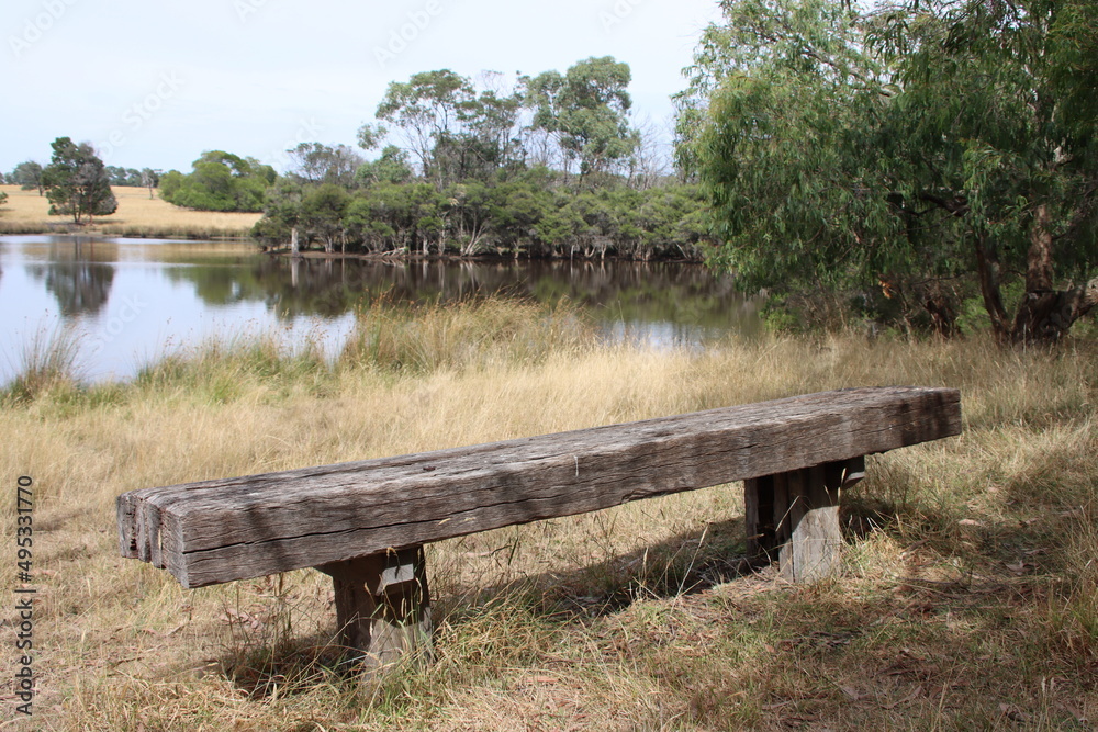 Rustic wooden seat in the Cranbourne Botanic Gardens, Melbourne, Australia. Rustic wooden seat in the Cranbourne Botanic Gardens, Melbourne, Australia.