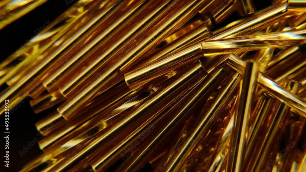 Gold beads. Shimmering beautiful golden texture. Gold beads. Shimmering beautiful golden texture. Abstract geometric background in gold and black colors. Rotation. High quality 4k footage Gold beads. Shimmering beautiful golden texture. Gold beads. Shimmering beautiful golden texture. Abstract geometric background in gold and black colors. Rotation. High quality 4k footage