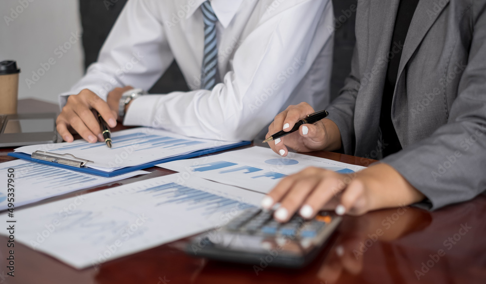 Fototapeta premium Two business leaders talk about charts, financial graphs showing results are analyzing and calculating planning strategies, business success building processes