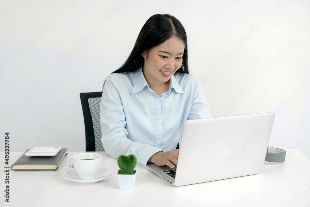 Asian woman working laptop. Successful smiling businesswoman sitting working at the office Asian woman working laptop. Successful smiling businesswoman sitting working at the office