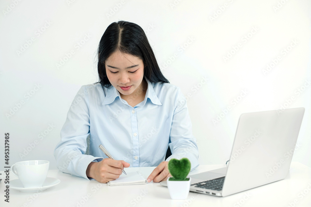 Asian woman working laptop. Successful smiling businesswoman sitting working and take note at the office Asian woman working laptop. Successful smiling businesswoman sitting working and take note at the office