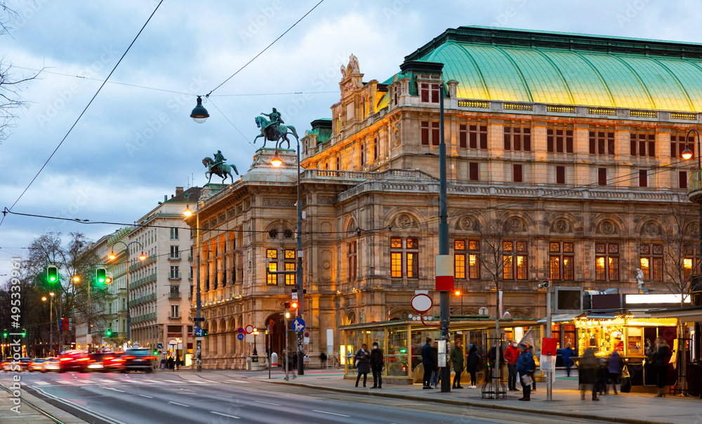 View of Opernring and Vienna State Opera building in evening. Section of Ringstrasse.