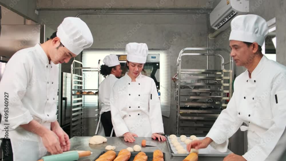 Multiracial professional gourmet team, four chefs in white cook