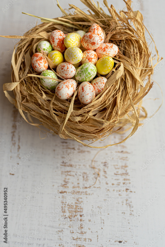 Easter background with Easter eggs in a nest. Top view with copy space. Easter holidays banner and header.