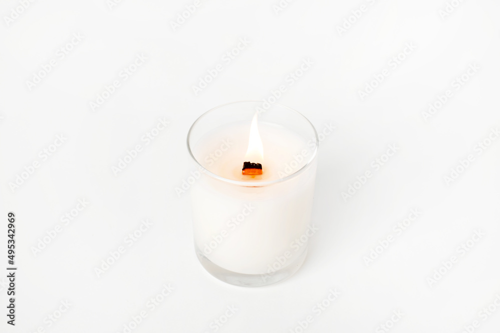 Soy candles in glass cans, handmade modern hobby , harmless coconut wax candles without paraffin with wood on white background isolated Soy candles in glass cans, handmade modern hobby , harmless coconut wax candles without paraffin with wood on white background isolated