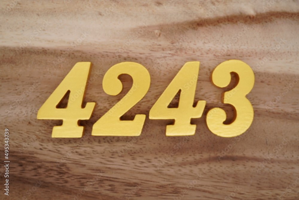 Golden Arabic numerals on a real brown and white wooden floor number ...