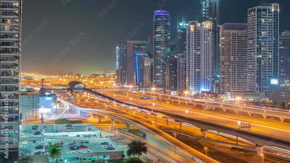 Dubai Marina skyscrapers and Sheikh Zayed road with metro railway aerial all night timelapse, United Arab Emirates Dubai Marina skyscrapers and Sheikh Zayed road with metro railway aerial all night timelapse, United Arab Emirates