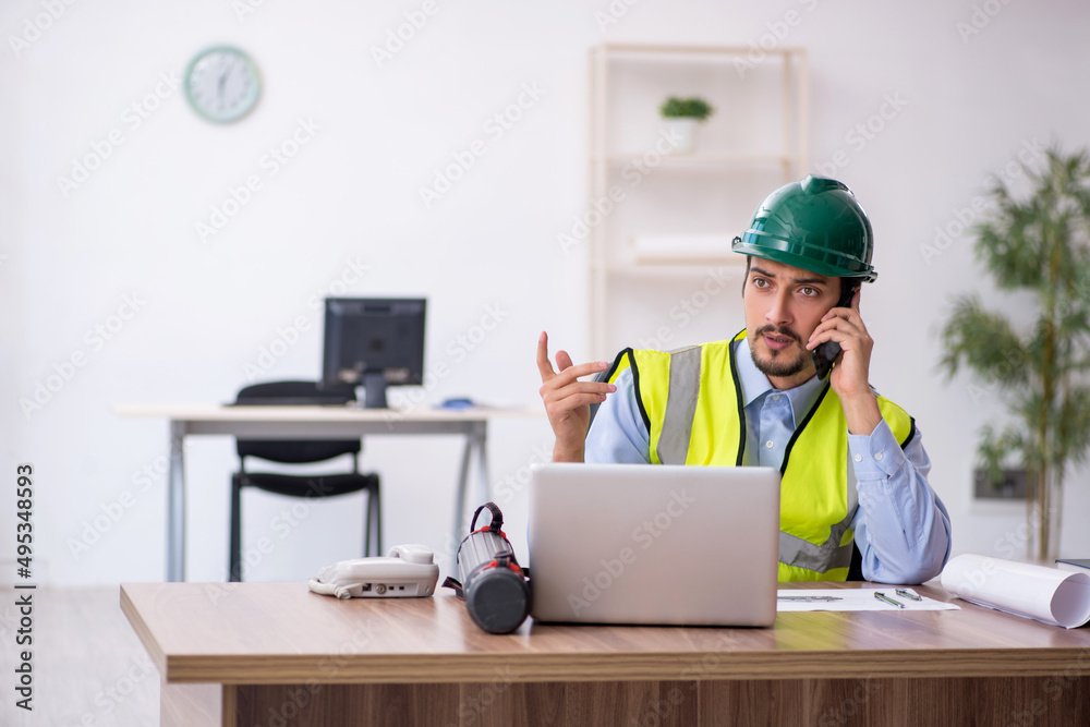 Young male architect working in the office Young male architect working in the office