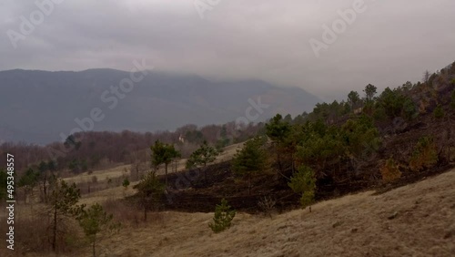 Effect of climate changes on hills after a fire left land destroyed photo