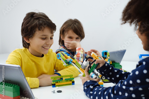 Canvas Print Coding Class, school girl constructing robot arm mechanism